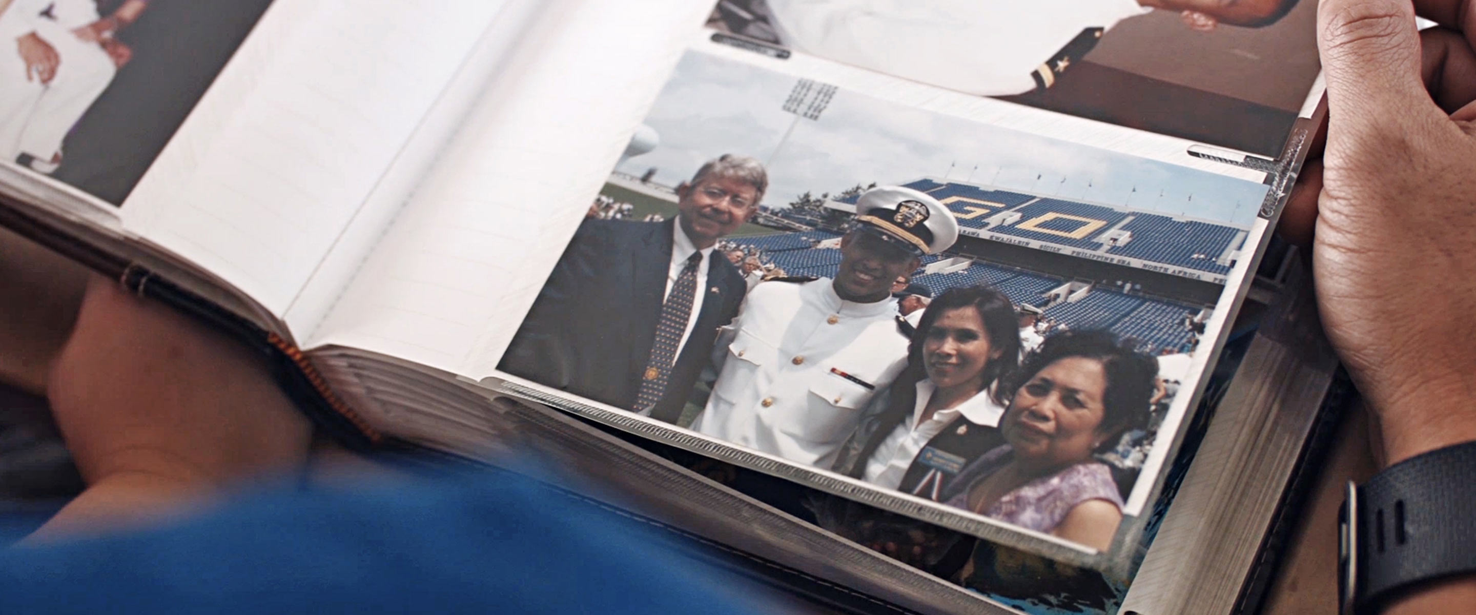 Navy Lieutenant Commander Scott Lieng looks at a photo of himself from the Naval Academy