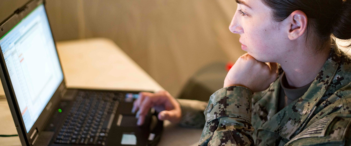 A United States Navy Information Systems Technician maintains a computer network as part of a Southern Partnership Station.