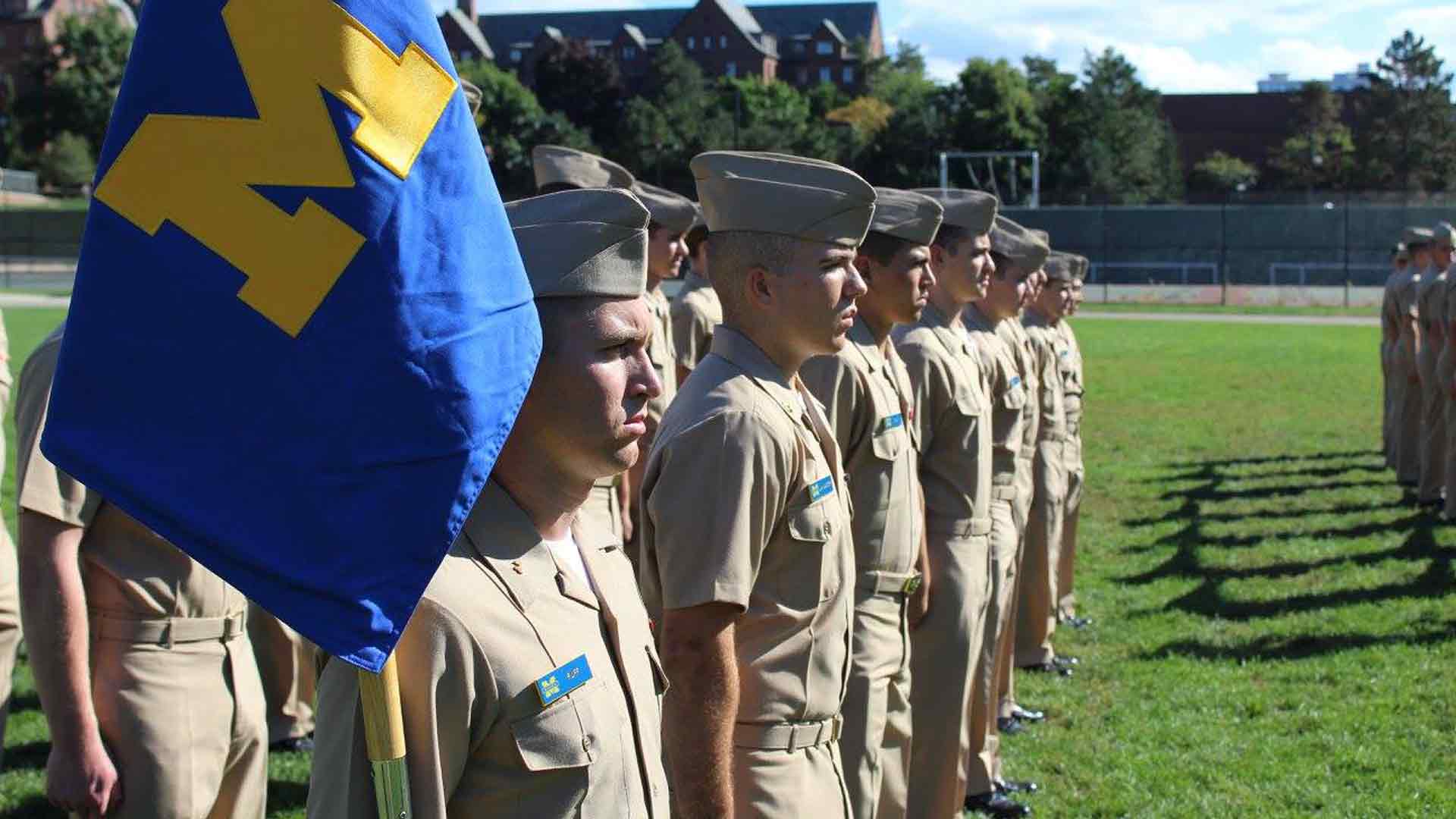 College students training for the United States Navy in ROTC stand in formation