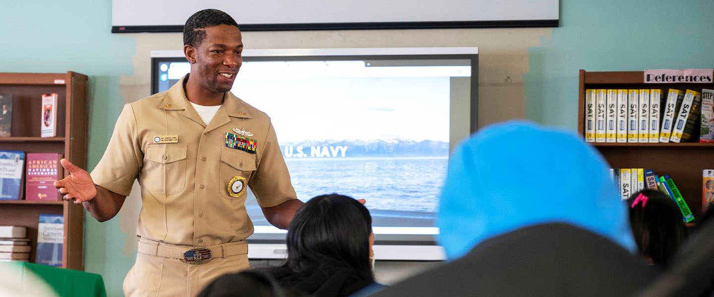 A U.S. Navy recruiter speaks with potential recruits.