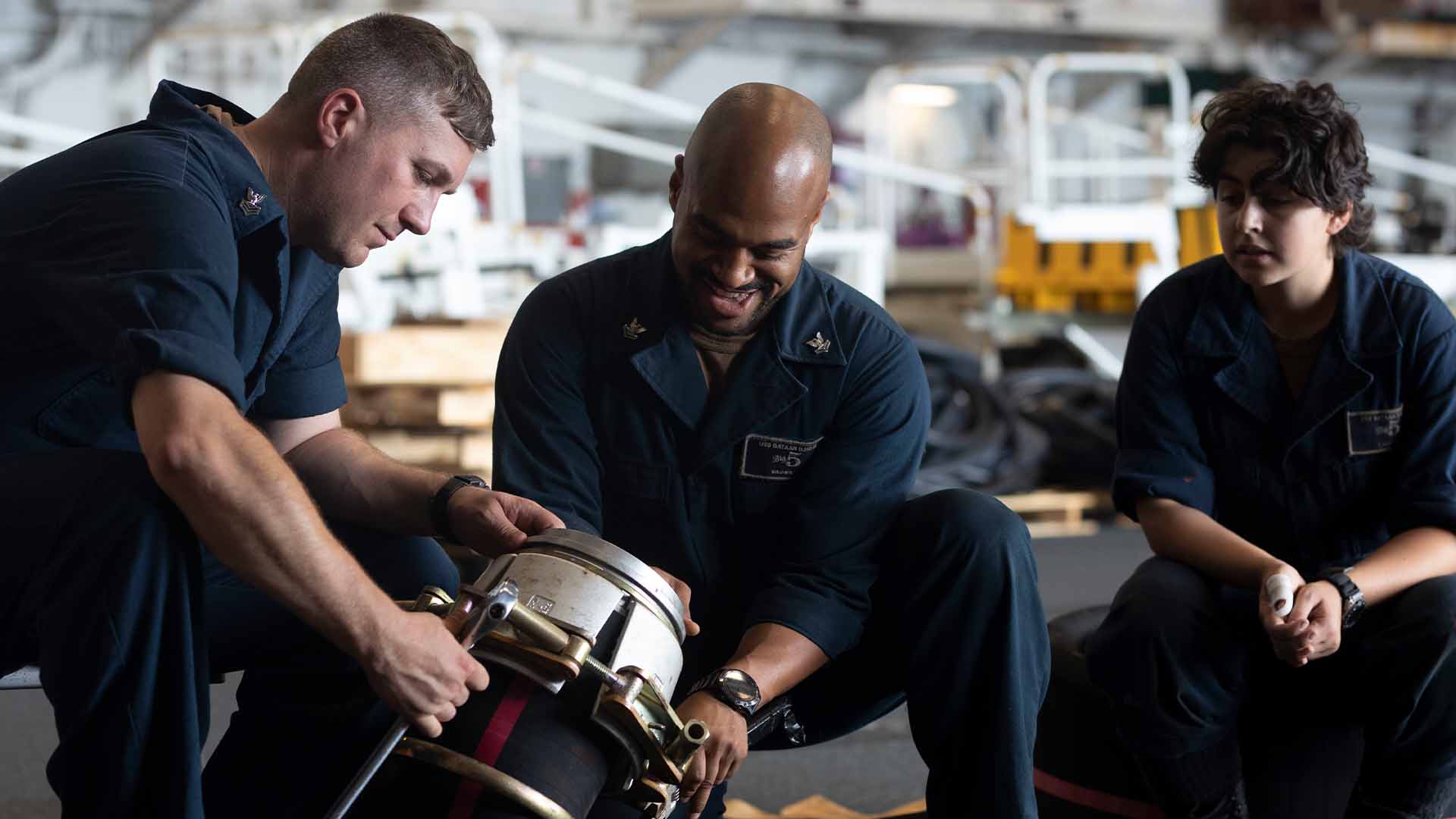 U.S. Navy Sailors performing ship maintenance.