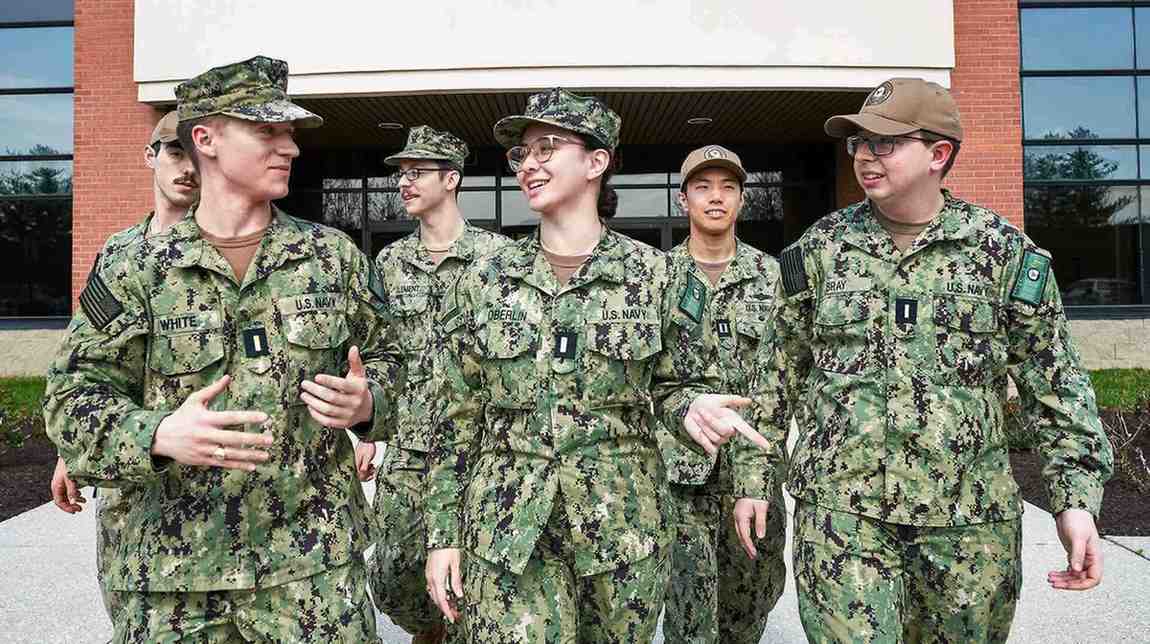 ENS Marie Oberlin walks with a group of fellow Cyber Warfare Engineers.