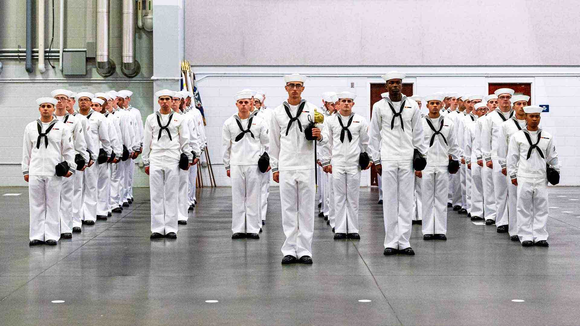 Navy Boot Camp graduates stand at attention as they attend graduation at Recruit Training Command in Great Lakes, IL. 